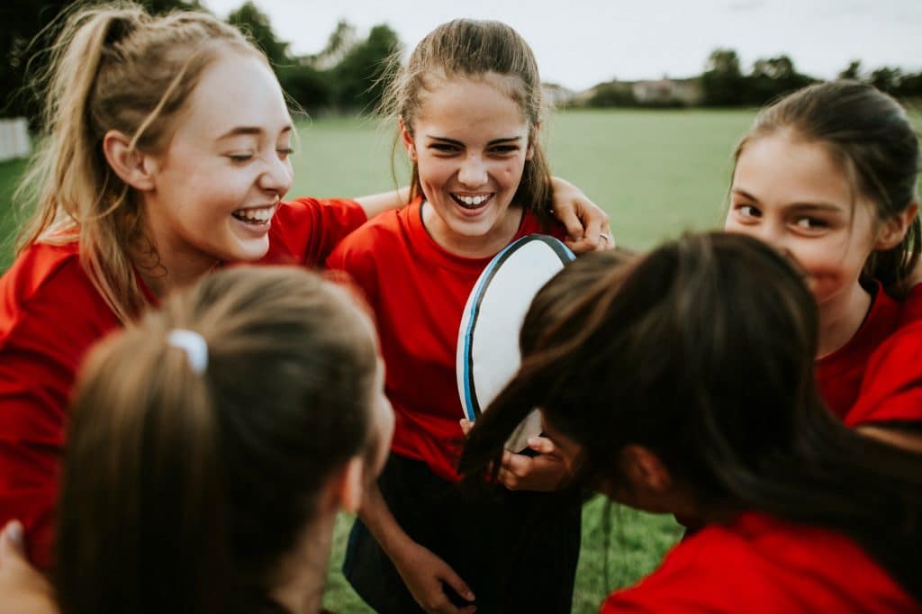 Cheerful young rugby players on the field