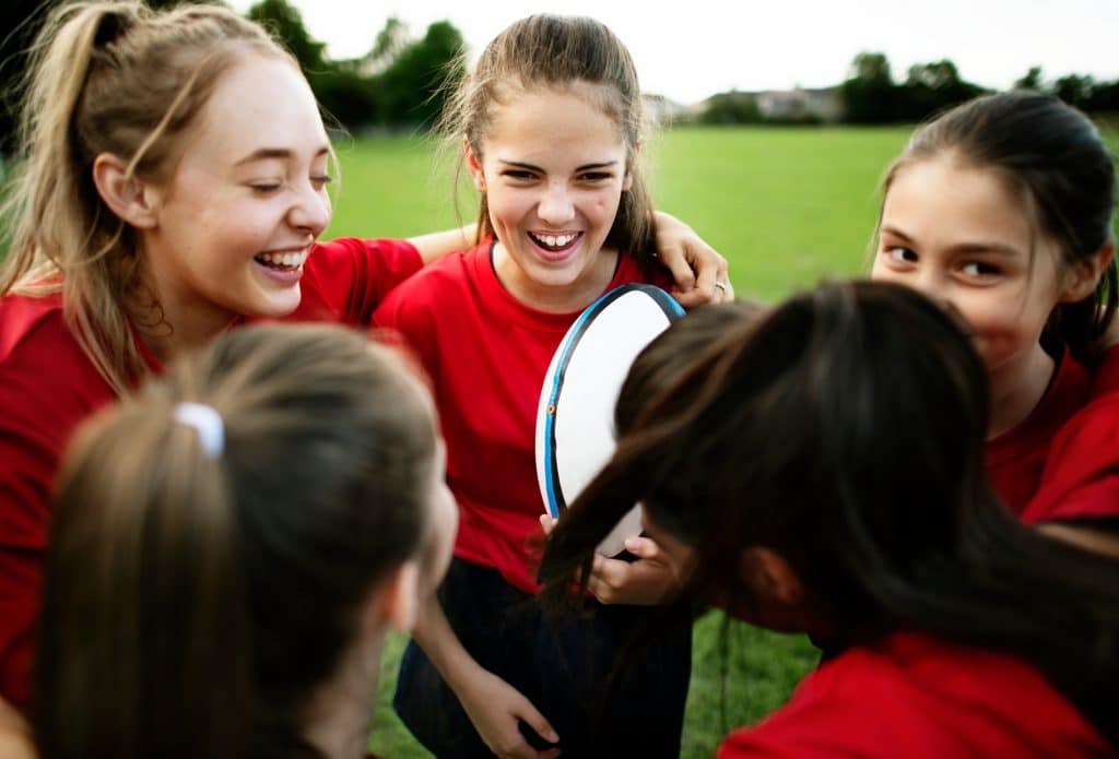 Cheerful young rugby players on the field