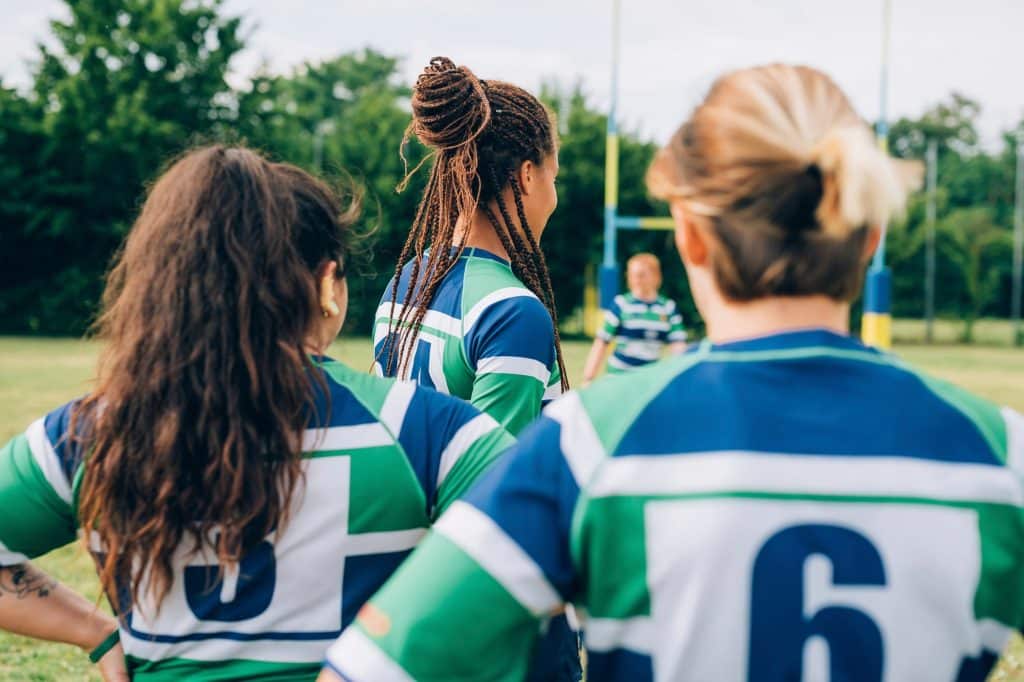 Female rugby players preparing for a match