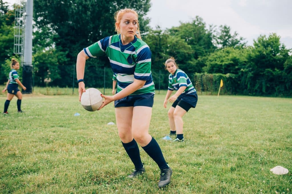 Rugby player in focus ready to pass the ball during a game